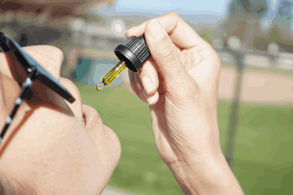 Une femme tenant un compte goutte d'huile full spectrum illustrant les différentes manieres de consommer des cannabinoides